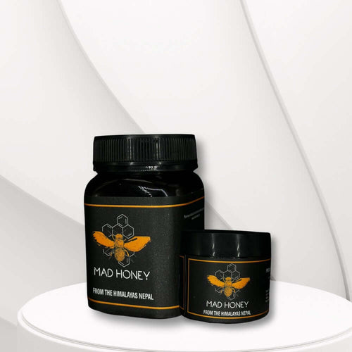 Two black containers of Golden Reserve Mad Honey on a white background

